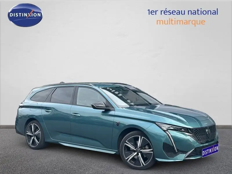 Peugeot 308 SW 2023 bleu métallisé en 3/4 avant droit avec jantes alliage et vitres surteintées.