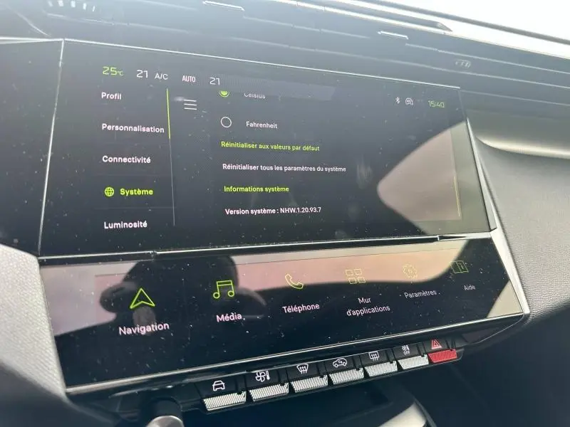 Écran tactile central du tableau de bord de la Peugeot 308 SW 2023, affichant les réglages système en intérieur noir.