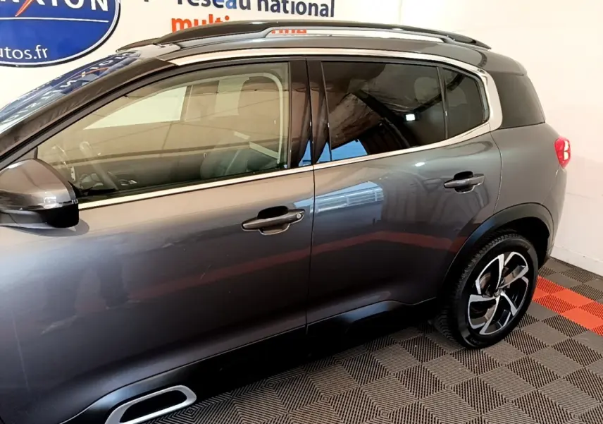 Vue latérale droite d'un Citroën C5 Aircross gris foncé avec jantes alliage et vitres teintées.