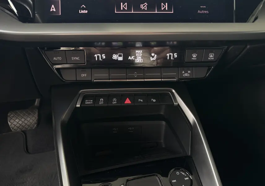 Vue rapprochée du tableau de bord et console centrale de l'Audi A3 Sportback 2021, avec commandes climatisation et boutons multifonctions.
