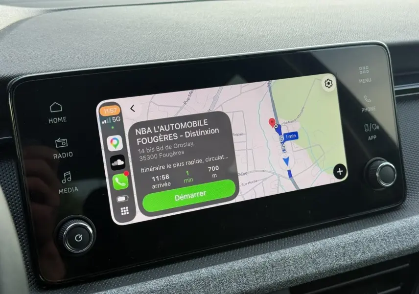 Écran tactile central 8,25" du Skoda Scala TSI 116 DSG7, affichant navigation GPS avec interface Apple CarPlay.