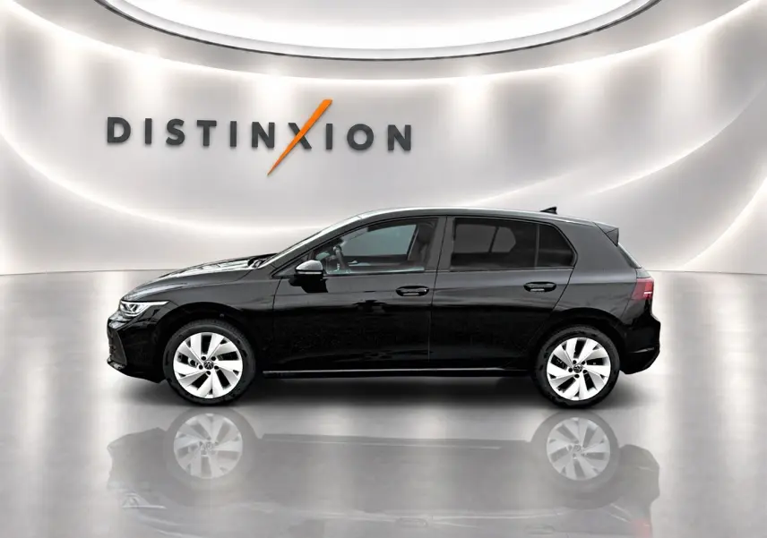 Profil côté gauche d'une Volkswagen Golf noire 2026 dans un showroom avec sol réfléchissant et logo Distinxion en arrière-plan.