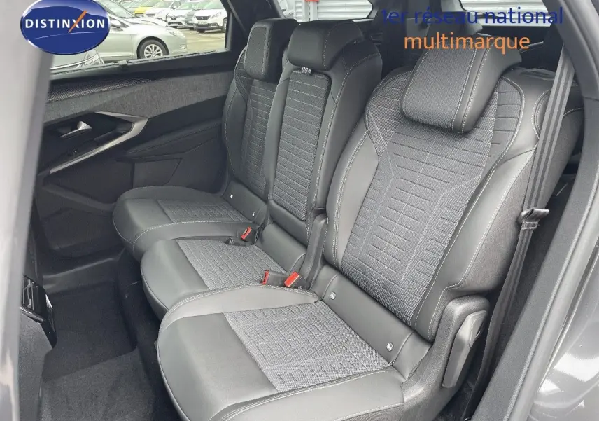Vue latérale droite des sièges arrière en cuir noir et tissu gris du Peugeot 5008 Hybrid 2025 gris titane toit noir.