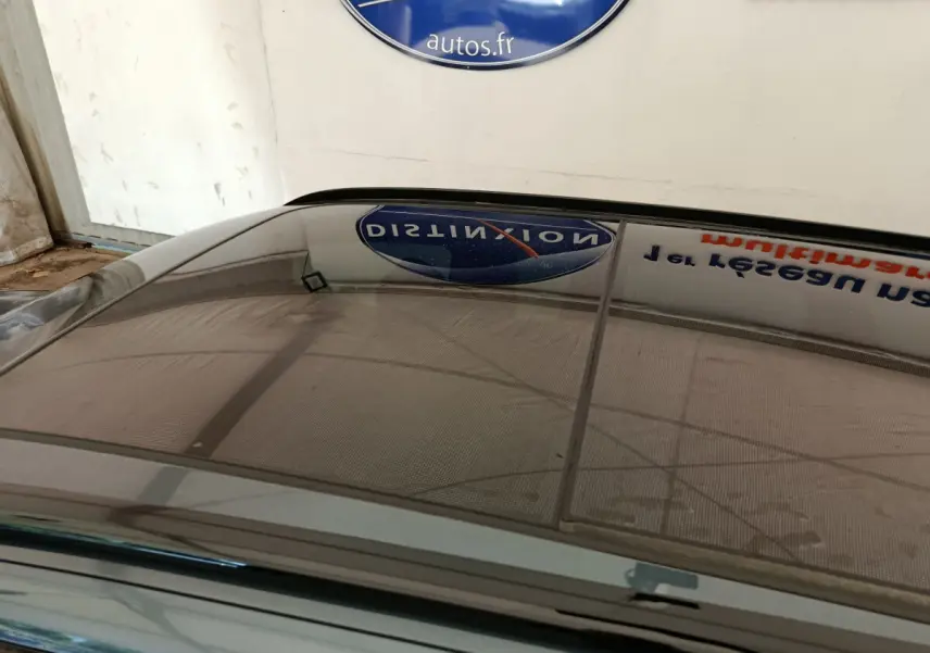 Toit panoramique en verre du break CUPRA LEON ST gris foncé vu de dessus dans un garage.