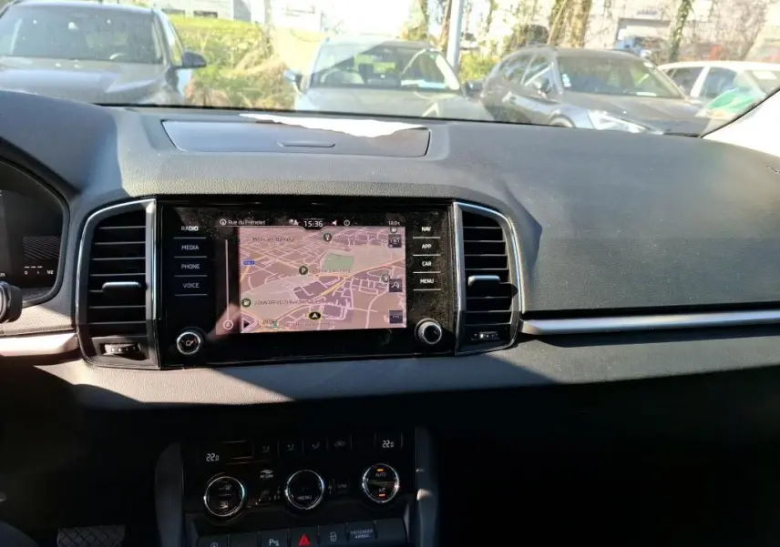 Intérieur noir du Skoda Karoq 2023 vu côté conducteur, avec volant multifonctions et console centrale moderne.