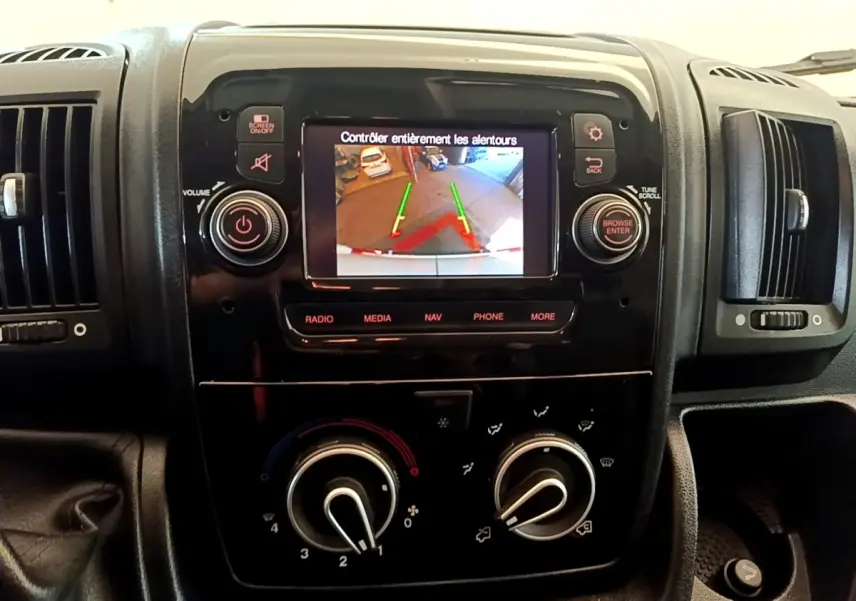 Vue rapprochée du tableau de bord noir du Fiat Ducato Fourgon 2021 avec écran tactile affichant la caméra de recul.