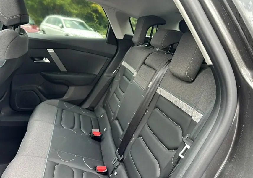 Vue intérieure côté droit sur la banquette arrière bicolore gris et noir du Citroën C4 2024.