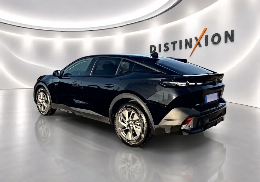 Peugeot 408 Hybrid noir vue 3/4 arrière droit dans un showroom avec jantes alu et vitres teintées.
