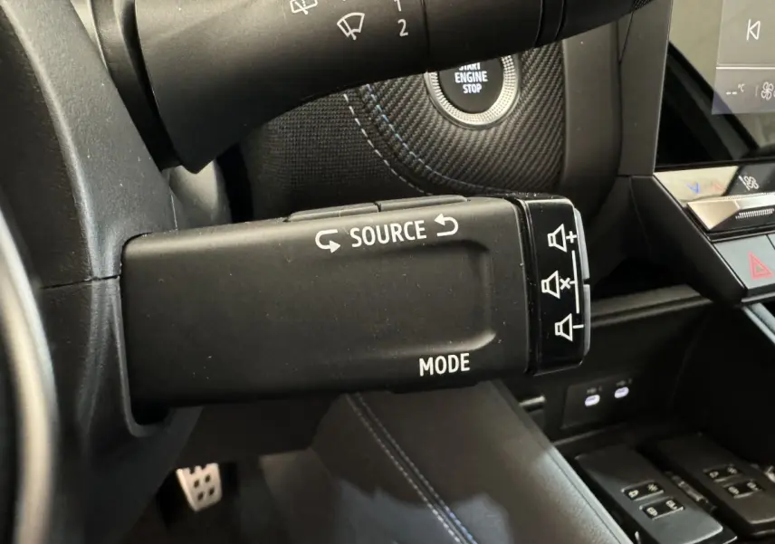 Gros plan sur la commande multimédia au volant du Renault Captur blanc esprit Alpine E-Tech 2025, intérieur noir.