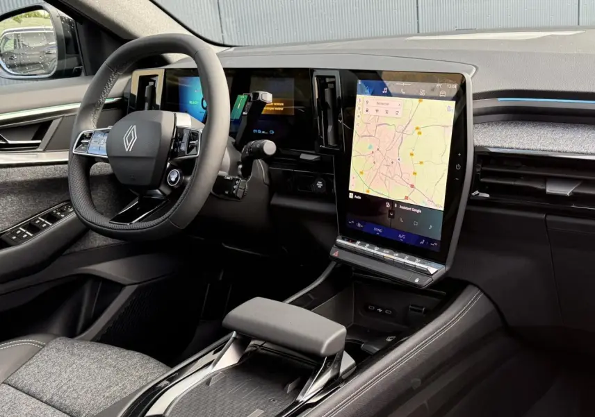 Intérieur côté conducteur du Renault Espace VI hybride noir, avec grand écran tactile vertical et volant multifonction.
