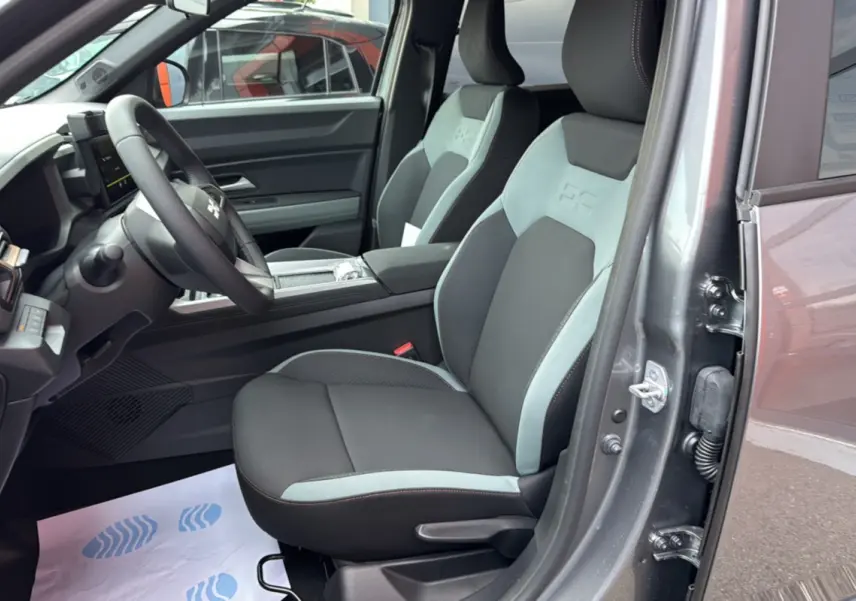 Vue intérieure côté conducteur du Dacia Bigster gris schiste, avec sièges bicolores et volant cuir soft feel.