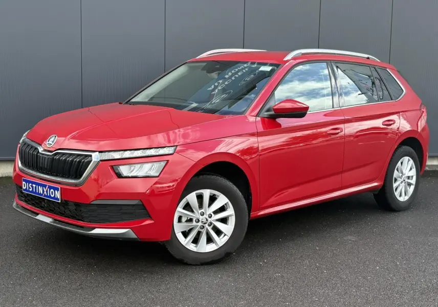 SKODA KAMIQ rouge Velvet en 3/4 avant droit, avec jantes alliage et barres de toit argentées visibles.