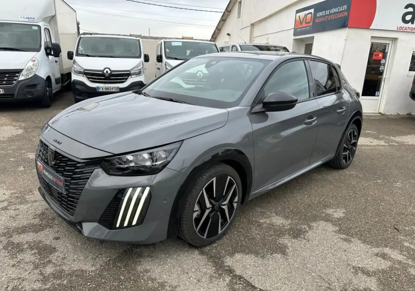 Peugeot 208 Hybrid 110 gris vue 3/4 avant droit, avec phares LED et jantes alliage 17 pouces distinctives.
