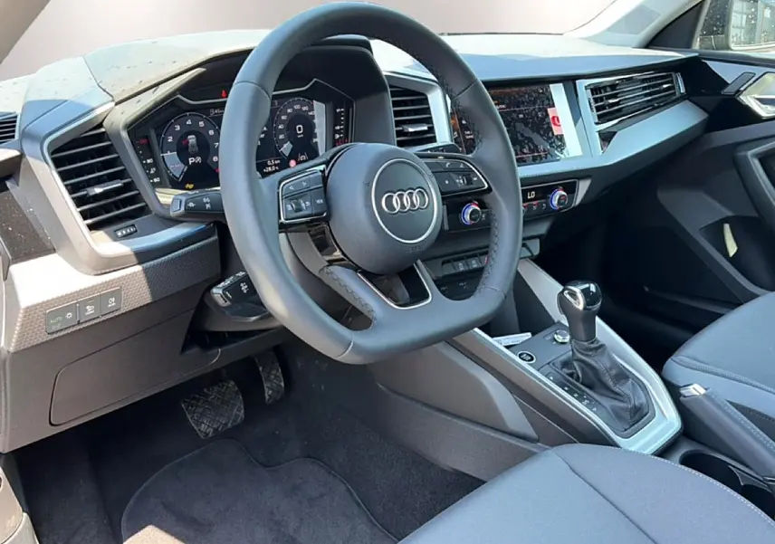 Intérieur avant droit de l'Audi A1 Sportback 30 TFSI 116 S line 2026, volant cuir multifonction et écran tactile.