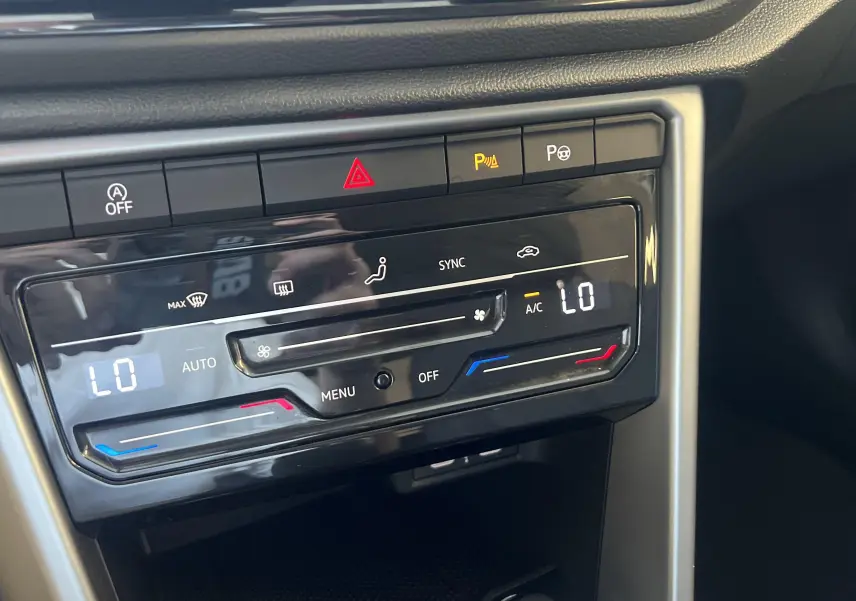 Panneau de commande de climatisation digitale du Volkswagen T-Roc gris Indium, avec réglages automatiques et boutons tactiles.