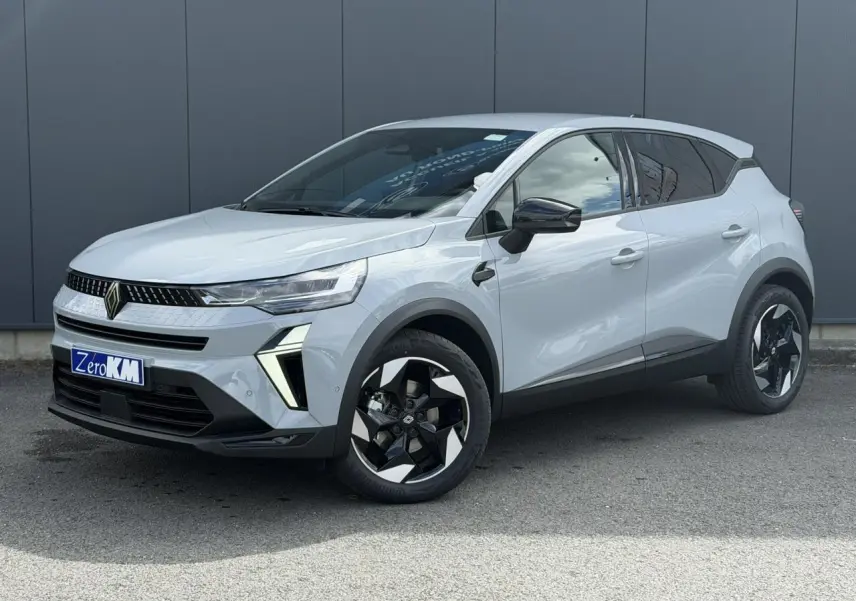 Renault Captur 2026 gris Rafale en 3/4 avant droit, avec jantes noires et détails lumineux LED distinctifs.
