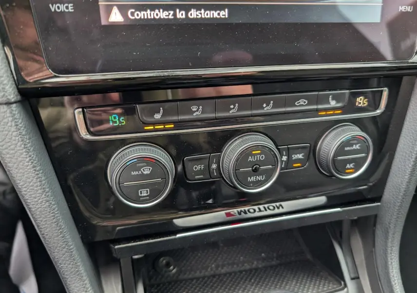 Détail de la console centrale noire de la Volkswagen Golf 2.0 TSI R 4Motion avec commandes de climatisation et sièges chauffants.