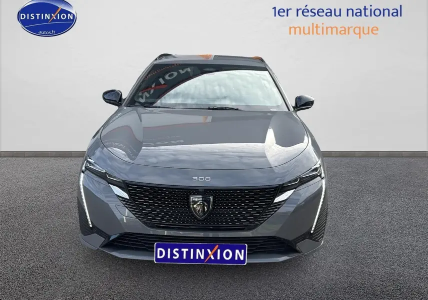 Vue frontale d'une Peugeot 308 SW Phev 225 GT gris selenium avec feux LED et calandre noire distinctive.