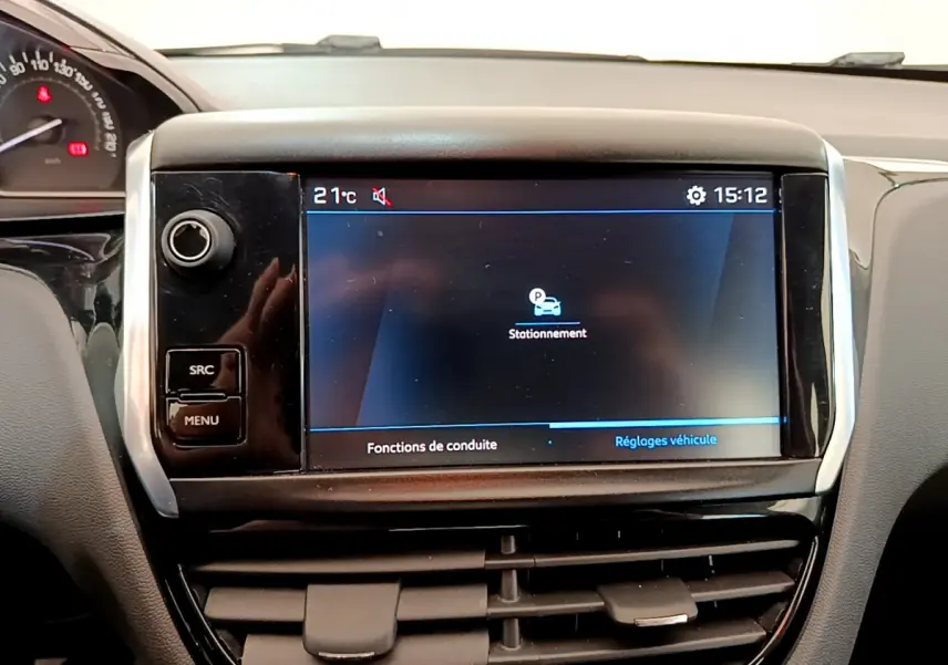 Écran tactile central affichant les réglages de stationnement dans l’habitacle noir d’une Peugeot 208 blanche Puretech 82 Signature.