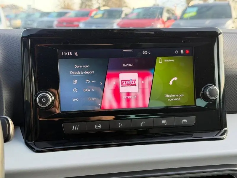 Écran tactile central du tableau de bord de la SEAT IBIZA 2025, affichant radio et informations de trajet.