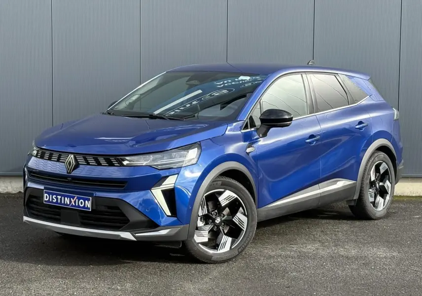 Renault Symbioz E-Tech Full Hybrid 2025 en bleu Iron, vue 3/4 avant avec jantes 18 pouces distinctives.