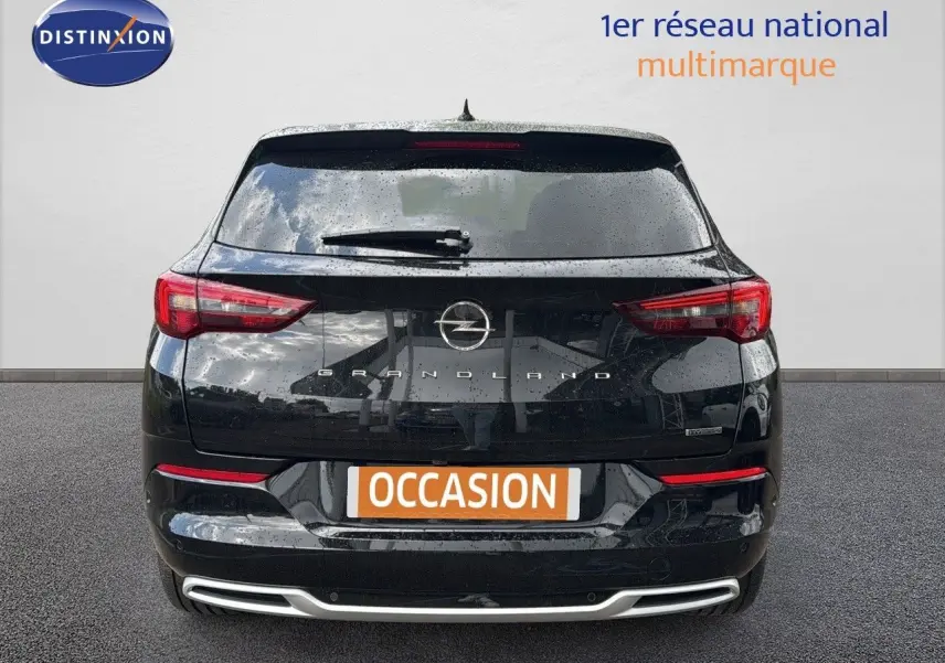 Vue arrière d'un Opel Grandland noir 2024 hybride rechargeable avec feux LED et logo central bien visibles.