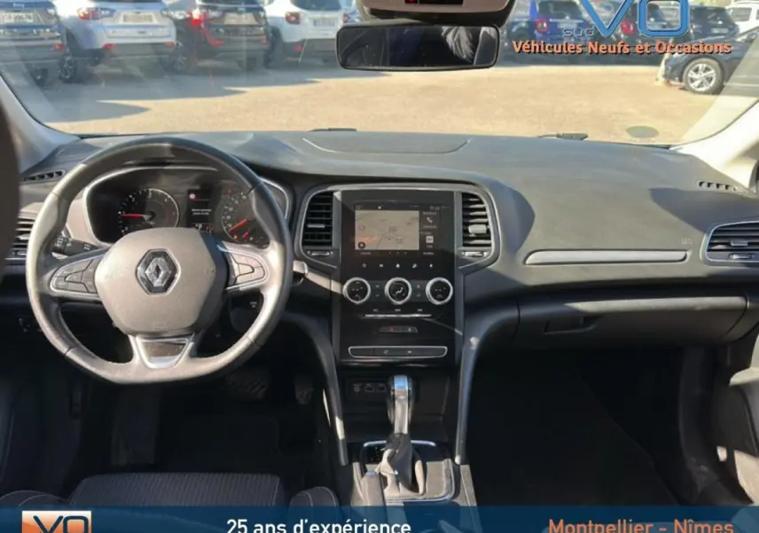 Intérieur de Renault Mégane IV Berline gris clair, vue frontale sur tableau de bord et volant multifonction.