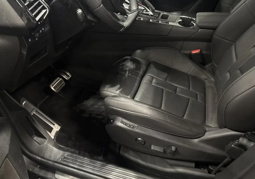 Vue intérieure côté conducteur du siège avant en cuir noir du DS7 Crossback 2025 avec réglages électriques et console centrale visible.