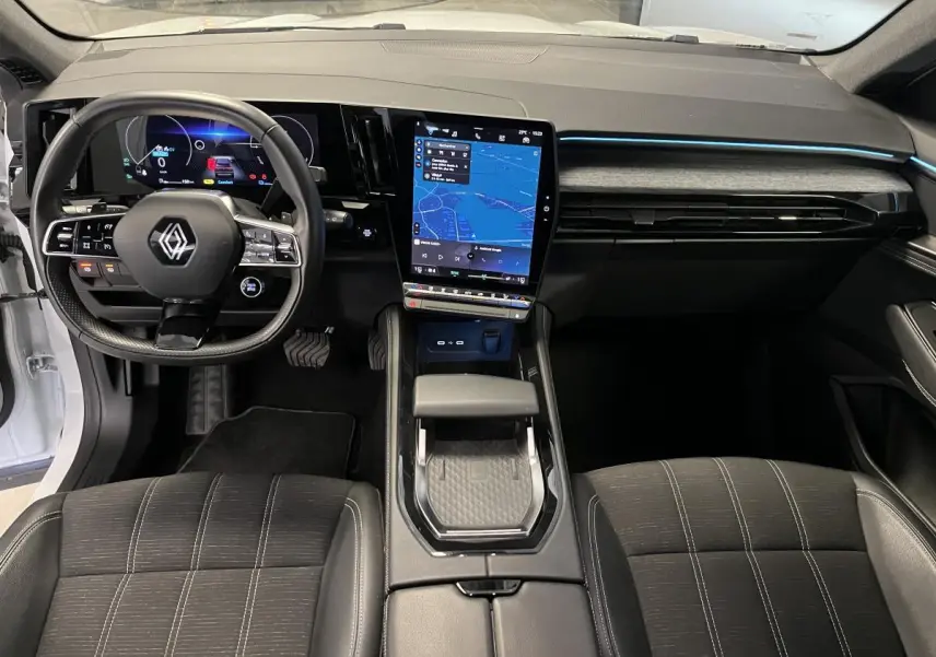 Intérieur du Renault Austral 2024, vue frontale du tableau de bord avec écran tactile vertical et volant multifonction.