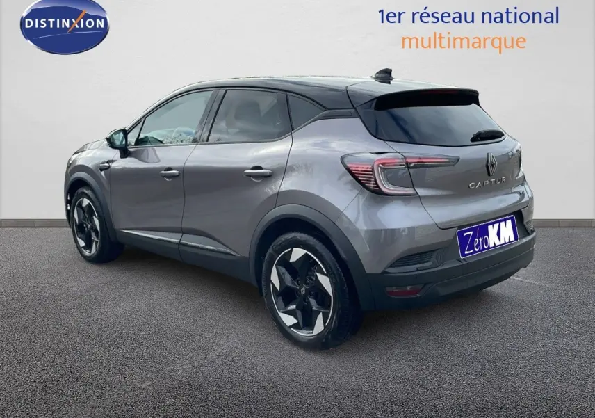 Renault Captur E-Tech hybride gris cassiopée métal avec toit noir, vue 3/4 arrière côté droit, jantes bi-ton.