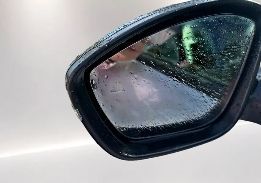 Rétroviseur extérieur droit noir d'une Citroën C3 Aircross 2026 avec gouttes de pluie et indicateur d'angle mort.