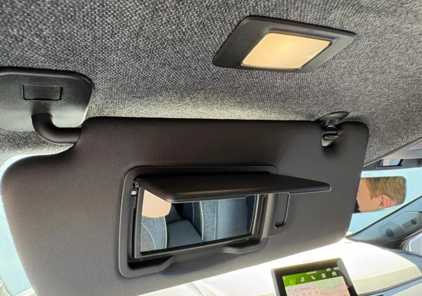 Miroir de courtoisie ouvert sur pare-soleil côté conducteur dans l’habitacle clair d’une Renault Symbioz blanc nacré.