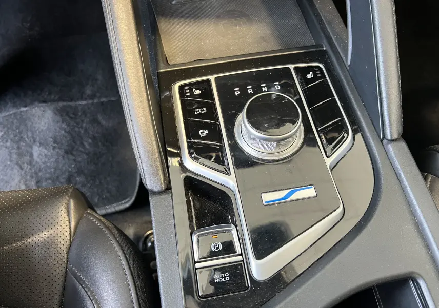 Gros plan sur la console centrale noire brillante du SERES 3 Electric 2022 avec sélecteur rotatif et commandes tactiles.