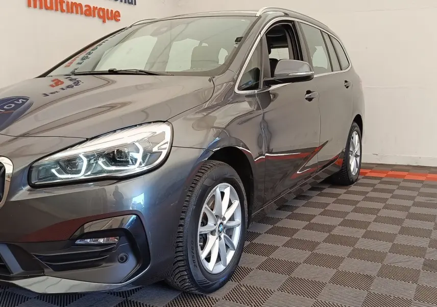 BMW Série 2 Gran Tourer gris clair vue 3/4 avant droit, phares LED et jantes alliage visibles.