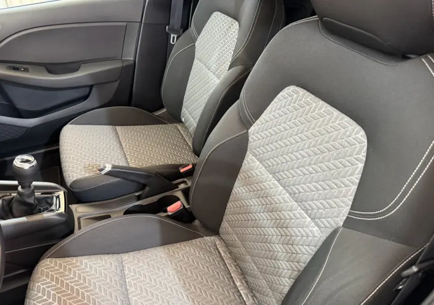 Gros plan sur les sièges avant gris et noirs de la Renault Clio Business TCe 100 GPL avec levier de vitesse manuel visible.