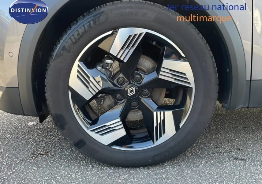 Gros plan sur la roue avant droite du Renault Symbioz gris cassiopée métal avec jante alliage noire et argentée.