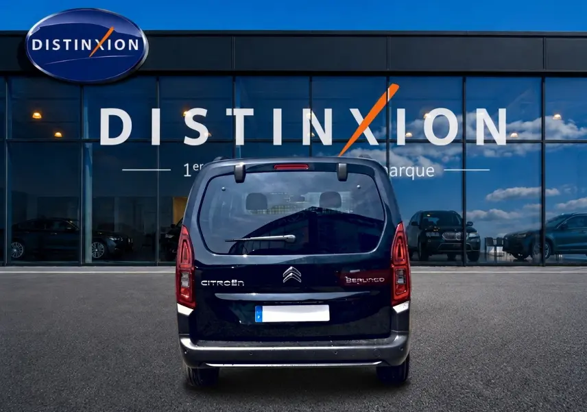 Vue arrière d’un Citroën Berlingo noir 2026 garé devant une vitrine avec logo Distinxion.