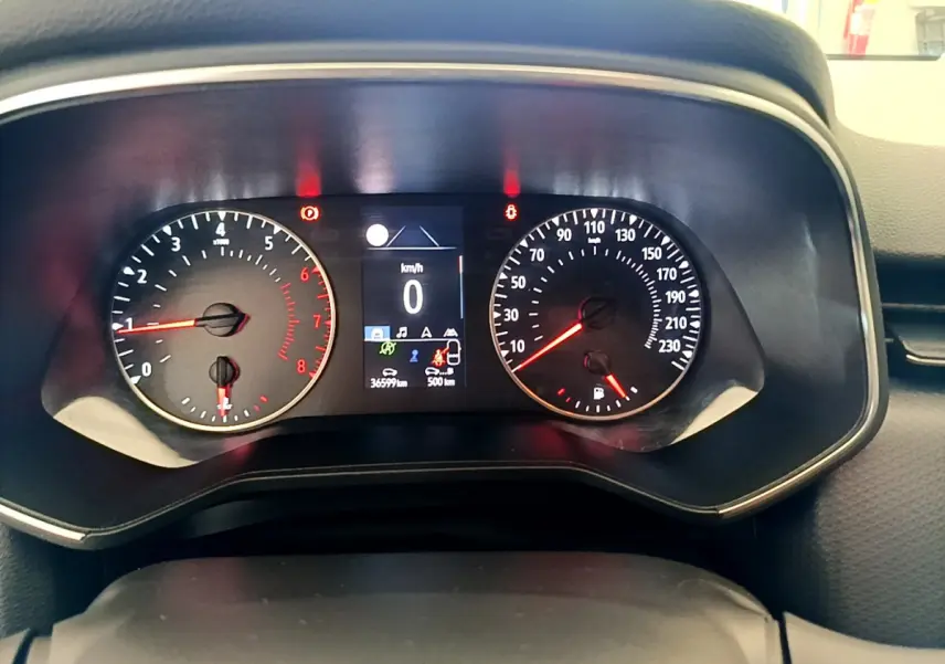 Vue rapprochée du tableau de bord de la Renault Clio Business blanc 2021 avec affichage digital et compte-tours analogique.