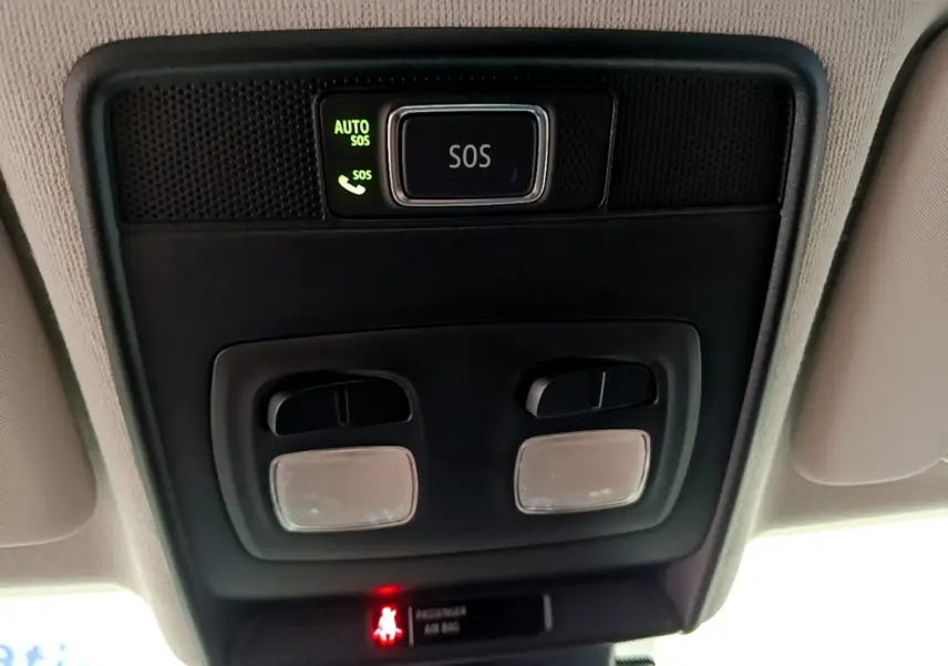 Vue en gros plan du plafonnier noir avec bouton SOS éclairé et commandes d'éclairage intérieur dans une Renault Clio blanche 2021.