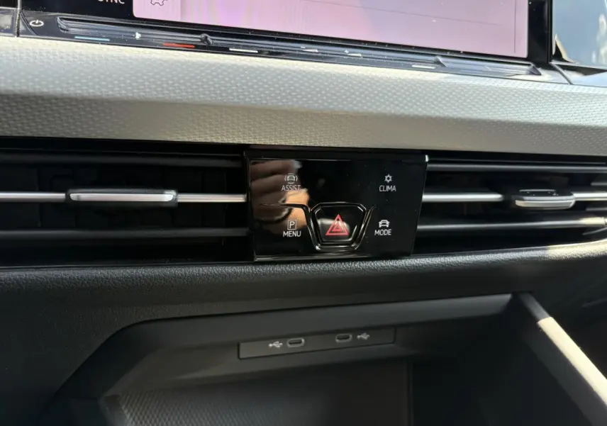 Détail du tableau de bord de la Volkswagen Golf VIII gris lunaire, avec commandes centrales et prises USB visibles.