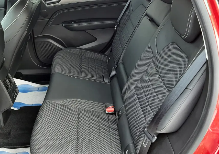 Vue intérieure côté droit des sièges arrière en tissu noir avec surpiqûres, dans un Renault Arkana Rouge Flame 2021.