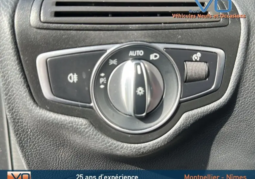 Gros plan sur le bouton de commande des phares dans l'habitacle d'un Mercedes GLC 300 de gris anthracite.