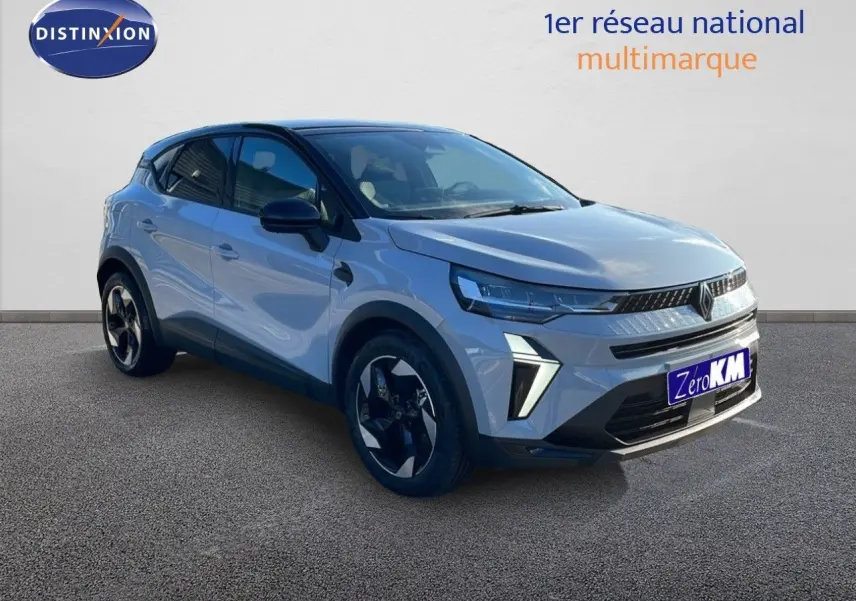 Renault Captur E-Tech hybride 2025 gris rafale métal avec toit noir, vue 3/4 avant mettant en valeur ses feux LED distinctifs.