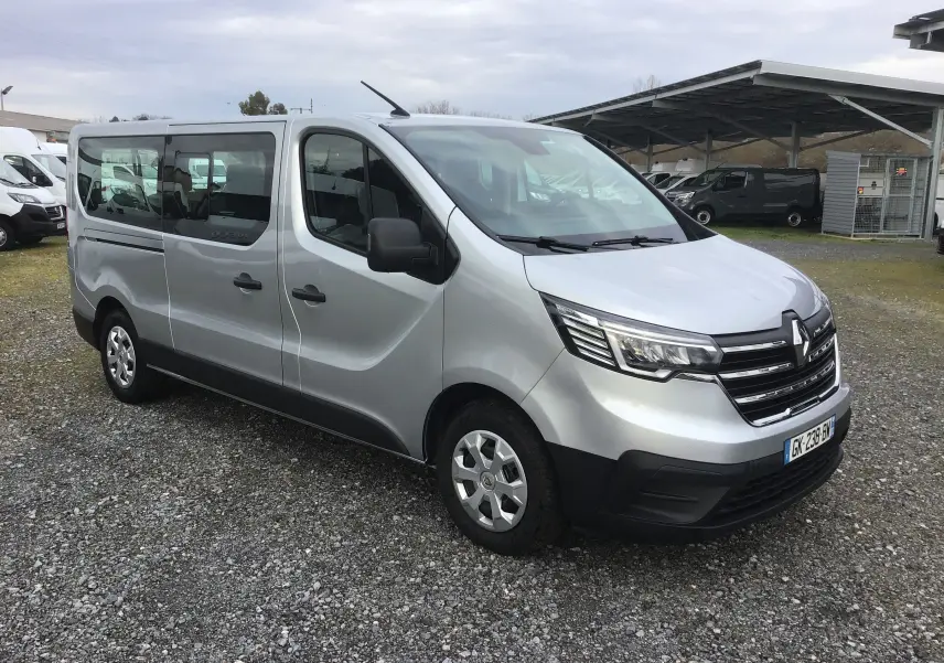 Renault Trafic Combi gris Highland en vue 3/4 avant droit, avec calandre noire et vitres latérales teintées.