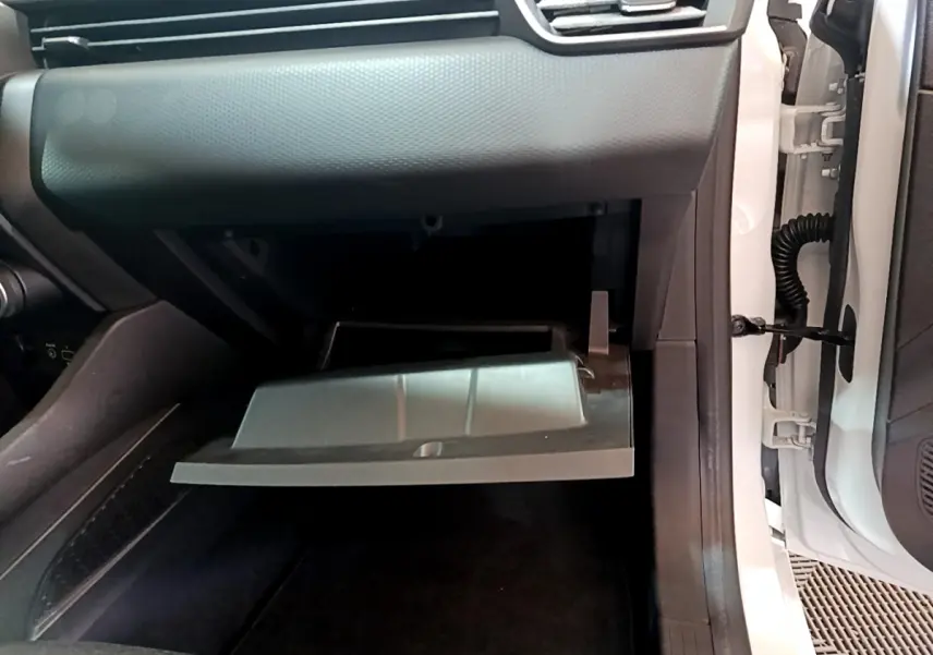 Vue intérieure côté passager de la boîte à gants ouverte dans une Renault Clio Business blanche de 2021.