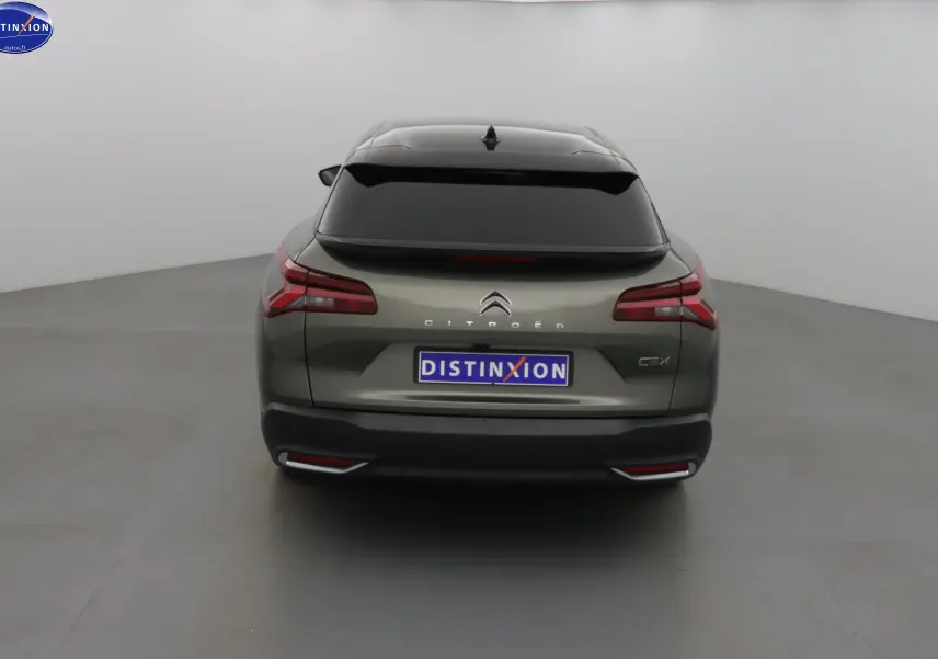 Vue arrière d'une Citroën C5 X gris smart avec feux LED et vitre arrière teintée dans un studio blanc.