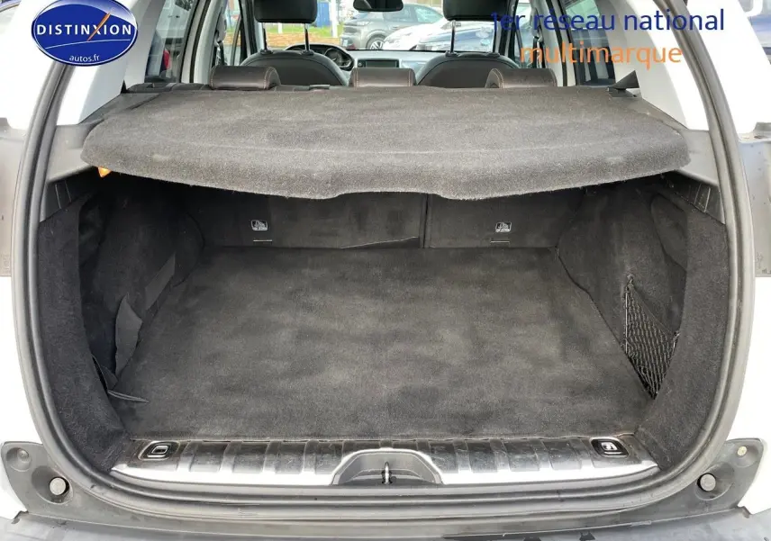 Coffre ouvert d'un Peugeot 2008 blanc de 2016, montrant un espace de chargement propre et bien fini.