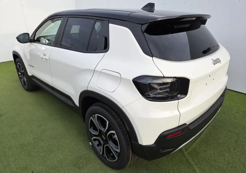 Jeep Avenger hybride 2025 vue 3/4 arrière côté gauche, carrosserie blanche Snow et toit noir Volcano.
