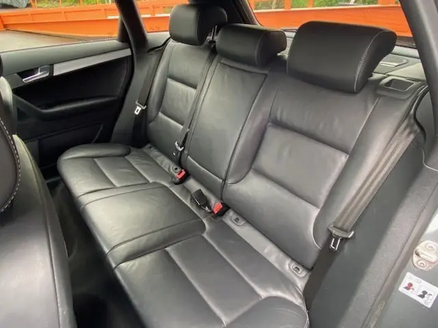 Vue intérieure sur les sièges arrière en cuir noir de l'Audi RS3 Sportback 2012, soulignant le confort et la finition soignée.