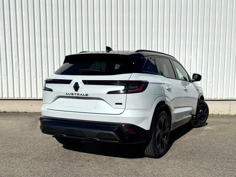 Vue 3/4 arrière droite du Renault Austral blanc nacré brillant avec toit noir et jantes noires.